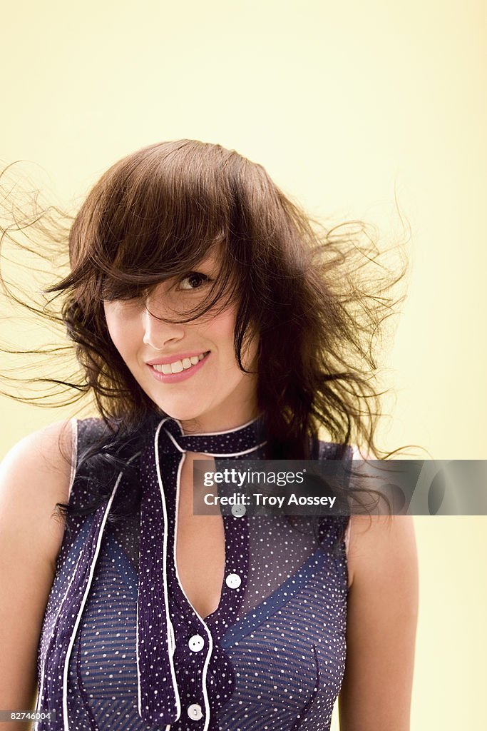 Young lady with windblown hair smiling