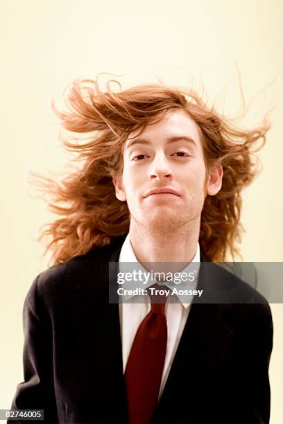 man with wind blown hair in business suit  - long hair wind stock pictures, royalty-free photos & images