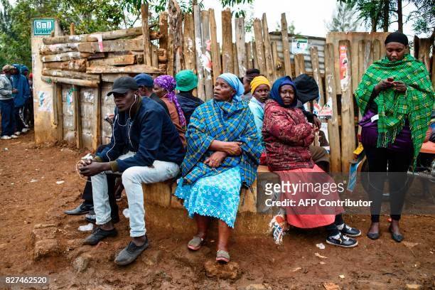 People wait to cast their ballot in the general elections at a polling station at Langas Primary School in the Rift Valley town of Eldoret, Kenya, on...