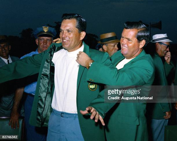 Bob Goalby is presented with the green jacket by Gay Brewer during the Presentation Ceremony at the Masters Tournament at Augusta National Golf Club...
