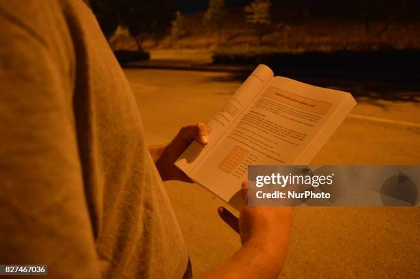 Man reads an educational book in Ankara, Turkey on August 07, 2017. The Turkish government takes a giant step in Turkey's education system with...