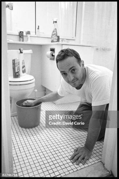 Author David Sedaris cleans his apartment at Astor Place on June 28, 1993 in New York City, New York.