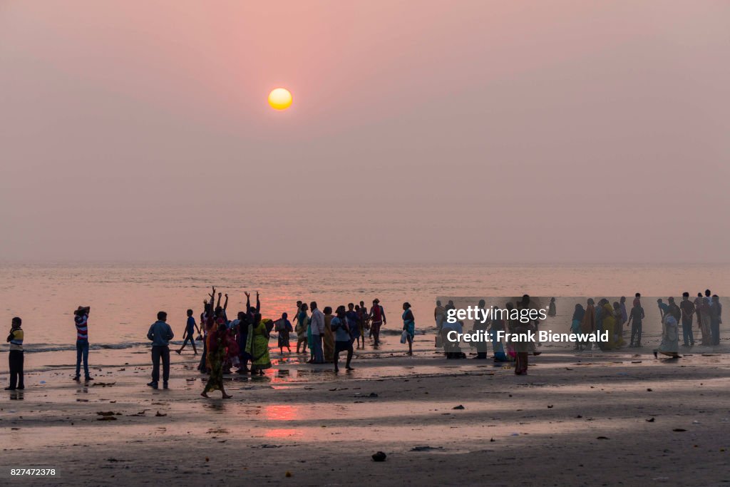 Hundreds of pilgrims are gathering on the beach of Ganga...