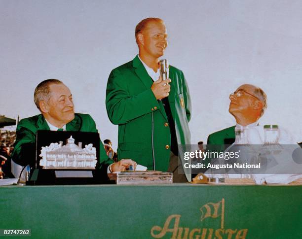 April 1963: Jack Nicklaus speaks at the presentation ceremony as Bobby Jones and Clifford Roberts look on during the 1964 Masters Tournament at...