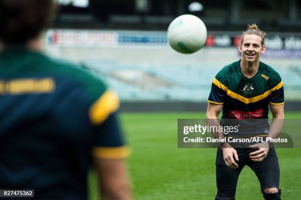 Nathan Fyfe of the Dockers kicks the round ball with Andrew Gaff of the Eagles during the media conference to confirm match dates in Adelaide and...