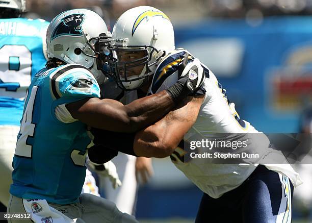 Linebacker Shawne Merriman of the San Diego Chargers fights the block of running back DeAngelo Williams of the Carolina Panthers on September 7, 2008...