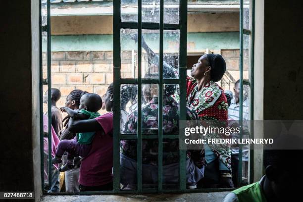 Voters queue in Kisumu on Lake Victoria on August 8 as the country goes to the polls in general elections. Kenyans began voting in general elections...