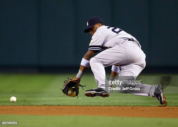 Second baseman Robinson Cano of the New York Yankees lunges for a ball hit by Reggie Willits of the Los Angeles Angels of Anaheim in the first inning...