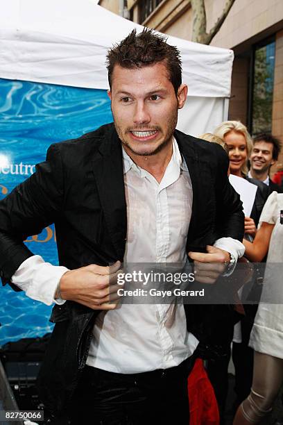 Host Jason Dundas poses wet straight out of the tank during the Cosmopolitan Neutrogena Underwater Fashion Shoot at Customs House on September 10,...