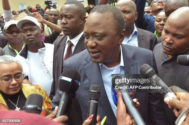 Kenya's President Uhuru Kenyatta speaks to the media after voting at a polling station during the August 8, 2017 presidential election in Gatundu,...