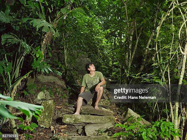 man resting on a staircase in the forest - las posas stock pictures, royalty-free photos & images