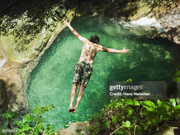 man jumping into a lake - las posas stock pictures, royalty-free photos & images