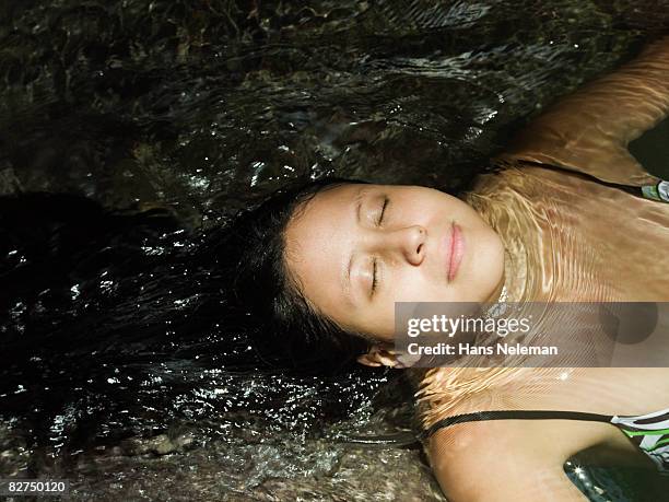 young woman floating in water - las posas stock pictures, royalty-free photos & images