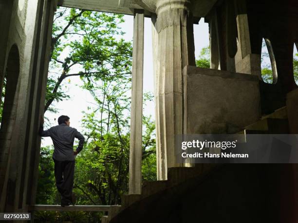 man in a surreal architectural structure - las posas stock pictures, royalty-free photos & images