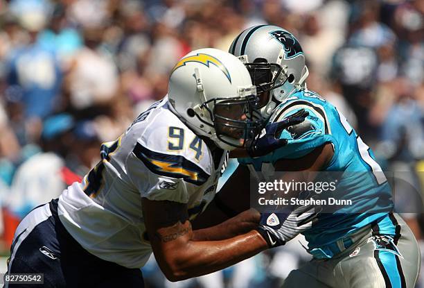 Linebacker Jyles Tucker of the San Diego Chargers fights the block of running back jonathan Stewart of the Carolina Panthers on September 7, 2008 at...