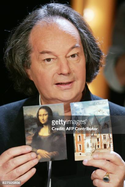 écrivain Gonzague Saint Bris pose avec une photo de La Joconde sur le plateau de l'émission littéraire de TF1, Vol de nuit, au cours de laquelle il...