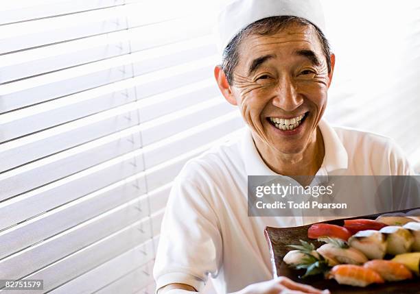 sushi chef displaying  sushi - sushi chef stock pictures, royalty-free photos & images