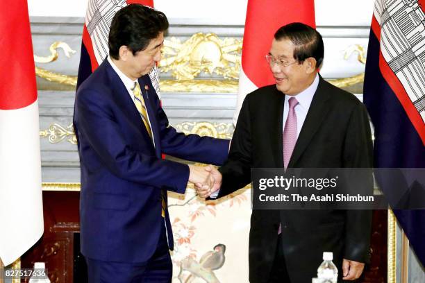 Cambodian Prime Minister Hun Sen and Japanese Prime Minister Shinzo Abe shake hands prior to their meeting at the Akasaka State Guest House on August...