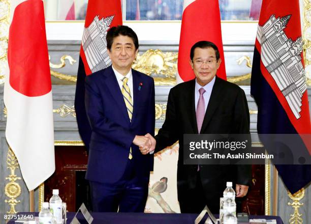 Cambodian Prime Minister Hun Sen and Japanese Prime Minister Shinzo Abe shake hands prior to their meeting at the Akasaka State Guest House on August...