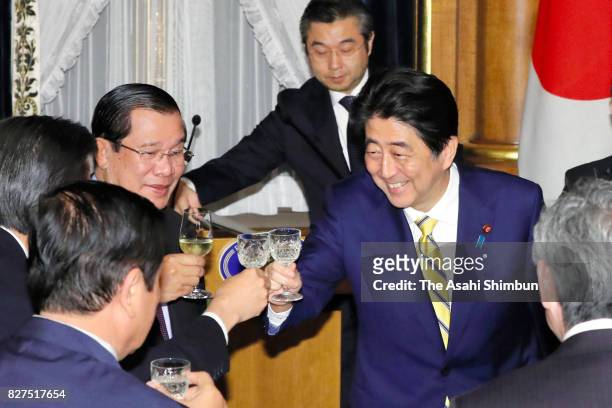 Cambodian Prime Minister Hun Sen and Japanese Prime Minister Shinzo Abe toast glasses during the dinner at the prime minister's official residence on...
