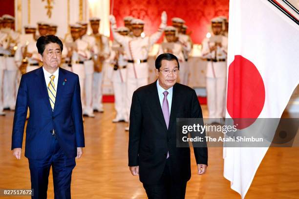 Cambodian Prime Minister Hun Sen reviews the honour guard with Japanese Prime Minister Shinzo Abe during the welcome ceremony at the Asakasa State...