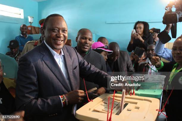 President of Kenya Uhuru Kenyatta casts his vote during the general elections, at the Mutomo Primary School polling station in Gatundu Neighborhood...