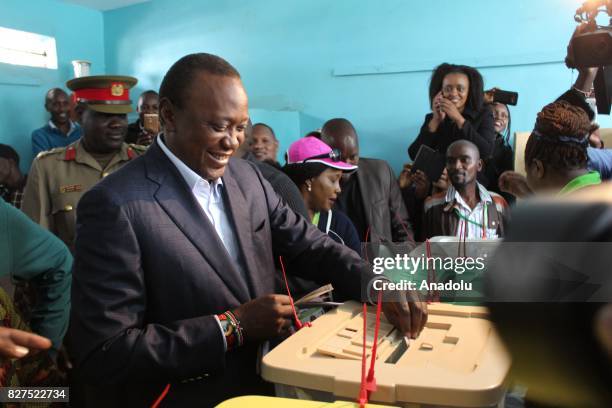 President of Kenya Uhuru Kenyatta casts his vote during the general elections, at the Mutomo Primary School polling station in Gatundu Neighborhood...