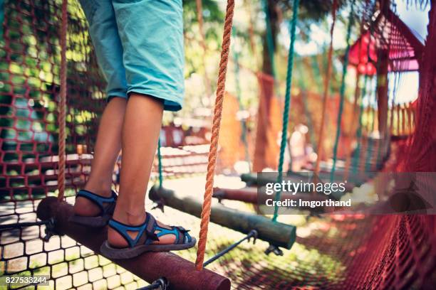 child walking in modern ropes course playground - safety netting stock pictures, royalty-free photos & images