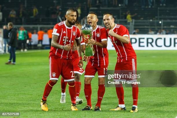 Arturo Vidal, Rafinha and Franck Ribery of Muenchen celebrate with the trophy after their team won the DFL Supercup 2017 match between Borussia...