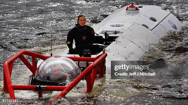 Diver stands on the LR7 rescue submarine is lowered into Loch Linnhe at Fort William where it is undergoing trials on September 10, 2008 in Fort...