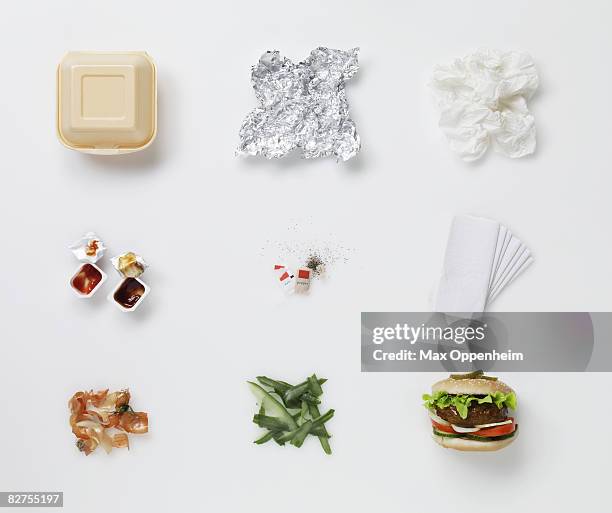 a hamburger aligned with all its associated waste  - garbage photos et images de collection