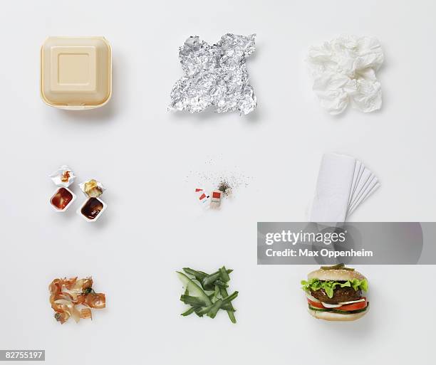a hamburger aligned with all its associated waste - empty food wrappers stock pictures, royalty-free photos & images