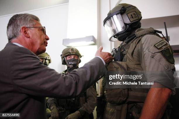 German Interior Minister Thomas de Maziere speaks with officiers of the Police special forces or GSG9 during the opening of the new Headquarters on...