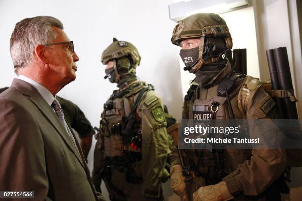 German Interior Minister Thomas de Maziere speaks with officiers of the Police special forces or GSG9 during the opening of the new Headquarters on...