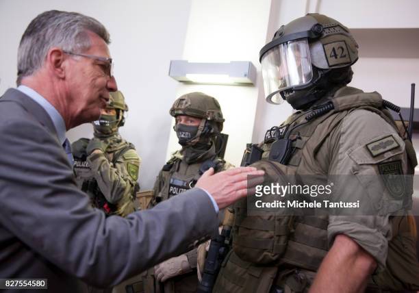 German Interior Minister Thomas de Maziere speaks with officiers of the Police special forces or GSG9 during the opening of the new Headquarters on...