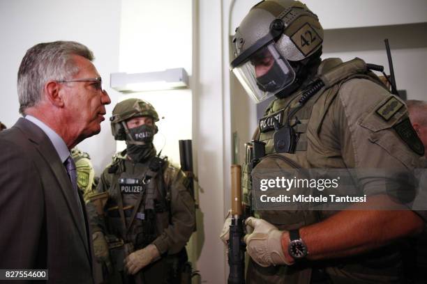German Interior Minister Thomas de Maziere speaks with officiers of the Police special forces or GSG9 during the opening of the new Headquarters on...