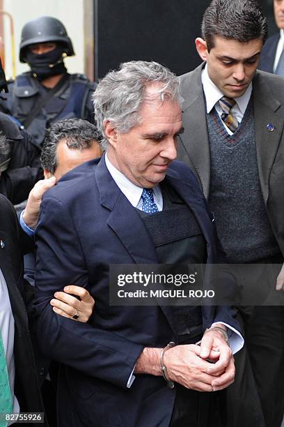Uruguayan banker Juan Peirano Basso is escorted to the police court in Montevideo on September 10, 2008 just after being extradited from the US on...
