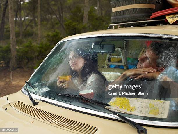 man and woman sit in car - car picnic stock pictures, royalty-free photos & images