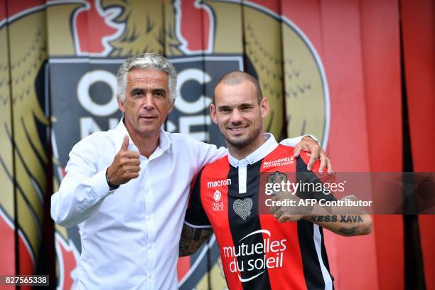 Nice's football club new signings Dutch midfielder Wesley Sneijder and Nice's football club French president Jean-Pierre Rivere pose on August 8,...