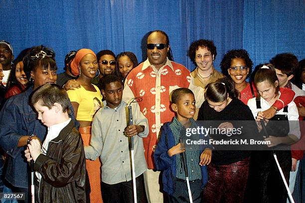 Children and celebrity performers join singer Stevie Wonder on stage during press conference for Stevie Wonder's 6th Annual House Full of Toys...