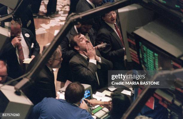 Trader on the New York Stock Exchange looks at stock rates 19 October 1987 as stocks were devastated during one of the most frantic days in the...