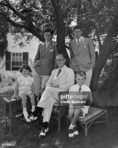 Portrait of American businessman Joseph P Kennedy Sr as he poses with his sons around him, clockwise from left, Edward Kennedy, John F Kennedy ,...