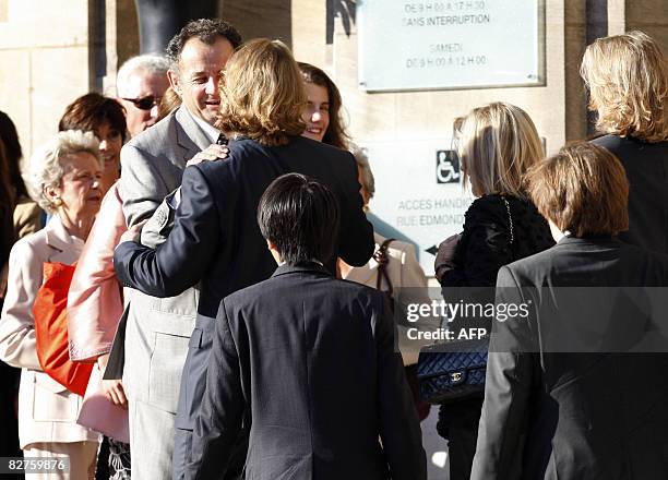 Jean Sarkozy, son of French President Nicolas Sarkozy hugs his uncle Guillaume Sarkozy as they arrive at the city hall in Neuilly-sur-Seine, outside...