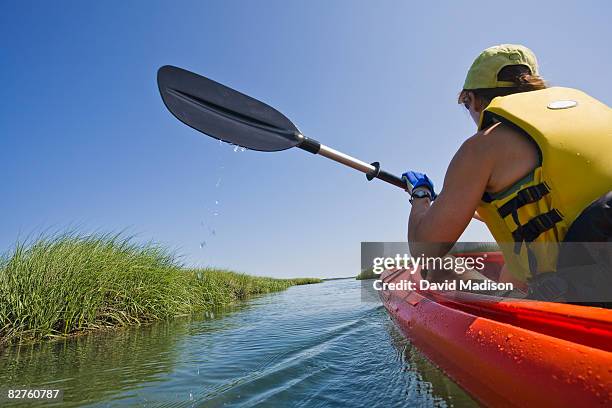 woman sea kayaking in cape cod - sea kayaking stock-fotos und bilder