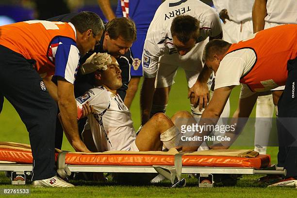 Joe Cole of England is helped on to a stretcher after injuring himself during the FIFA 2010 World Cup Qualifying Group Six match between Croatia and...