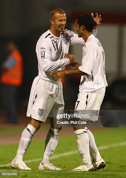 David Beckham of England congratulates team mate Theo Walcott on his hat-trick, as he comes on as a substitute during the FIFA 2010 World Cup...