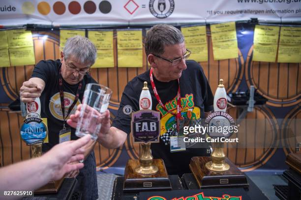 Bar staff serve visitors at the CAMRA Great British Beer festival at Olympia exhibition centre on August 8, 2017 in London, England. The five day...