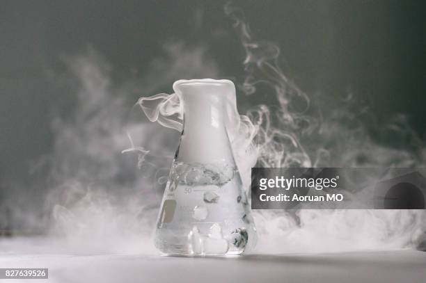 smoky conical bottle - dry ice stock pictures, royalty-free photos & images