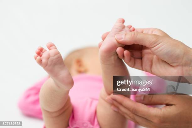 baby massage - adult gymnast feet stock-fotos und bilder
