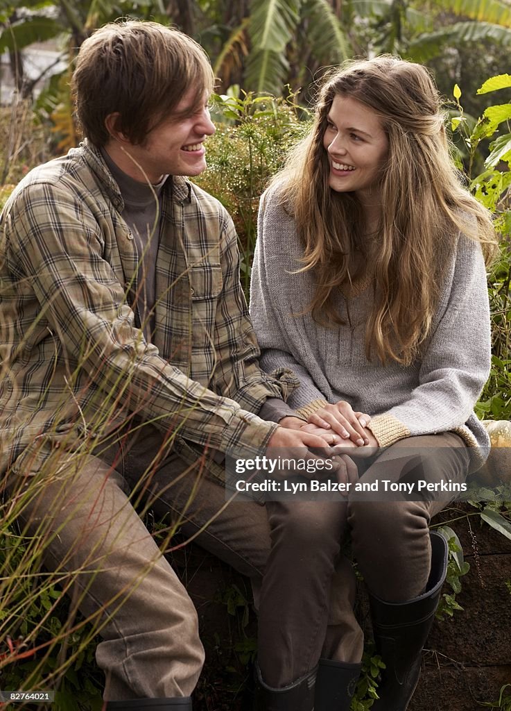 Teens holding hands in garden